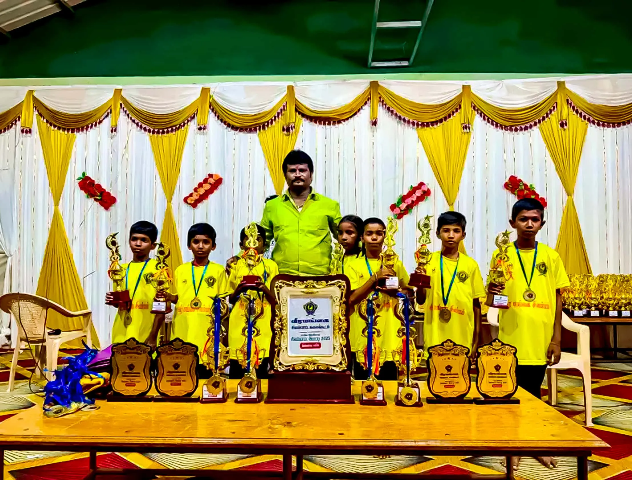 KPN Roofing Shed founder with young sports achievers and their trophies